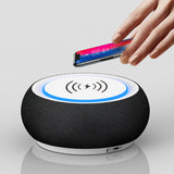 Black wireless charging pad with a hand placing a smartphone on it against a white background