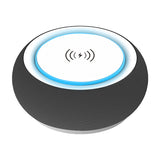 Black smart speaker with a blue light on a white background