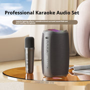 Professional karaoke audio set with microphone and speaker on a table.