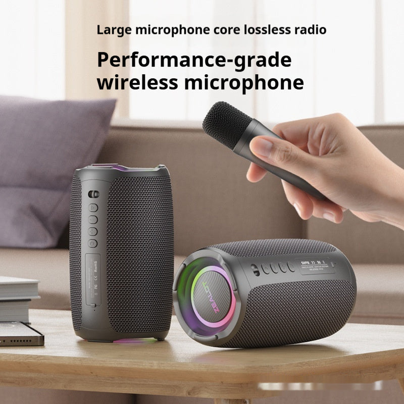 Two wireless microphones on a table with a hand holding one, in a home setting.