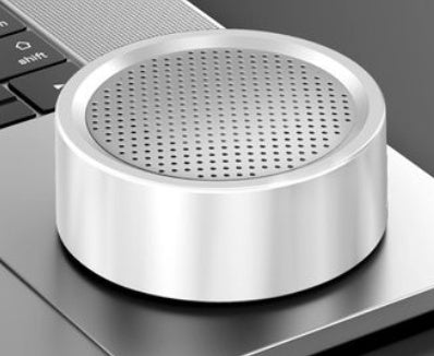 Metallic speaker grille on a laptop keyboard