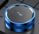 Blue and silver cylindrical speaker on a dark surface