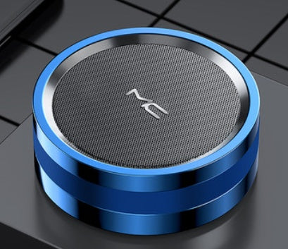 Blue and silver cylindrical speaker on a dark surface