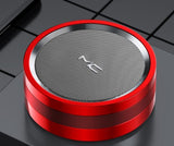 Red and silver portable speaker on a black grid background