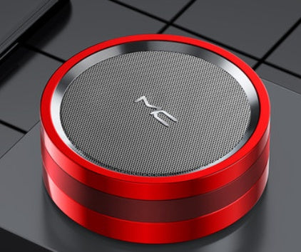 Red and silver portable speaker on a black grid background