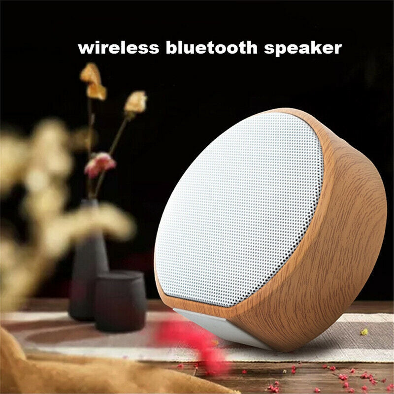 Wooden wireless Bluetooth speaker on a table with a blurred background