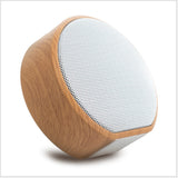 Wooden speaker with white mesh on a white background