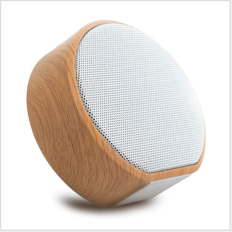 Wooden speaker with white mesh on a white background