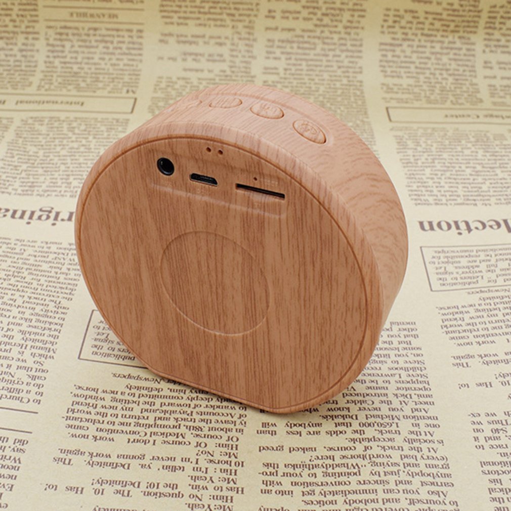 Wooden Bluetooth speaker on a newspaper background