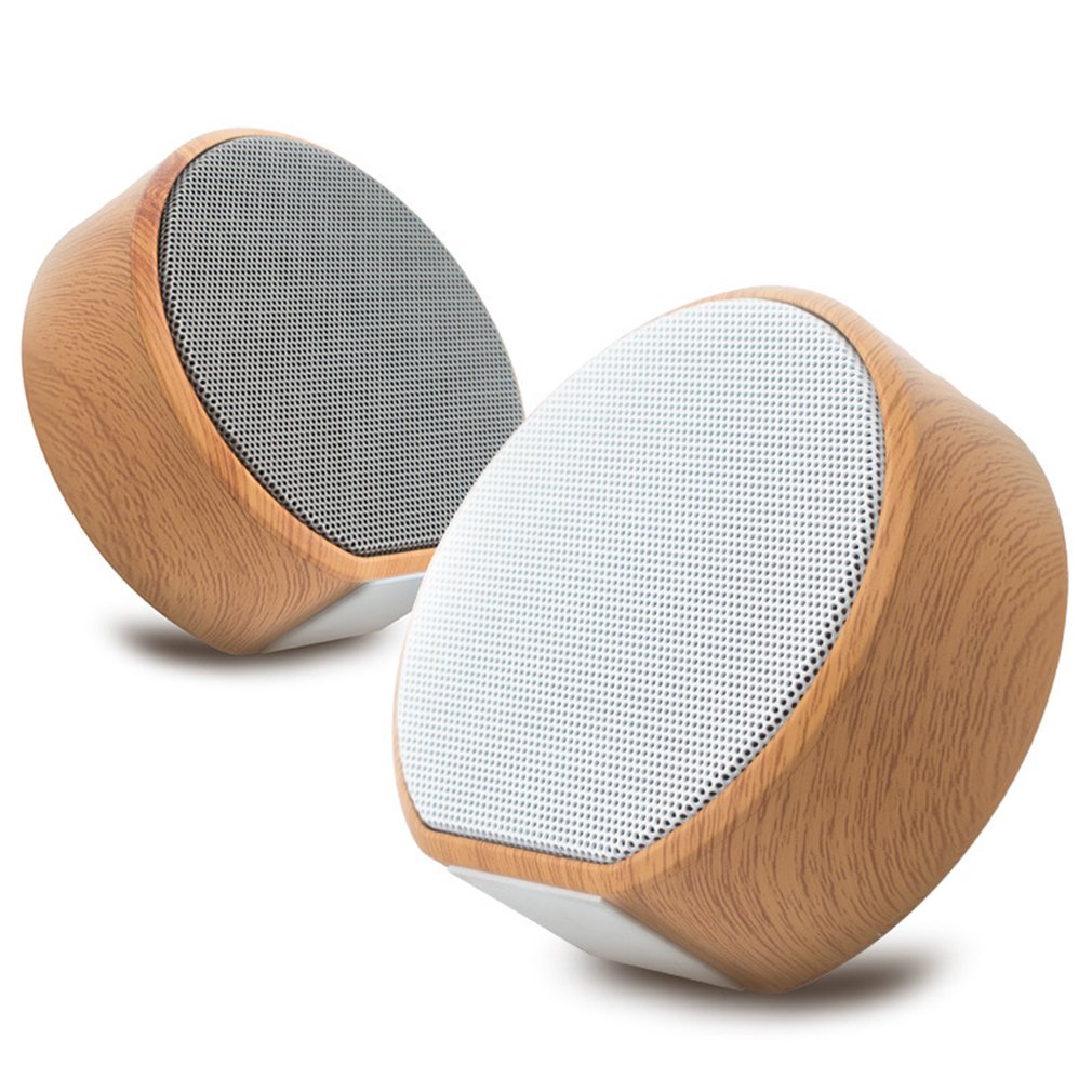 Pair of wooden speakers with white mesh on a white background