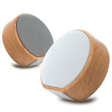 Pair of wooden speakers with white mesh on a white background