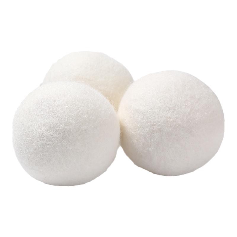Three white dryer balls on a white background