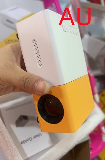 Hand holding a small electronic device with 'AU' branding.