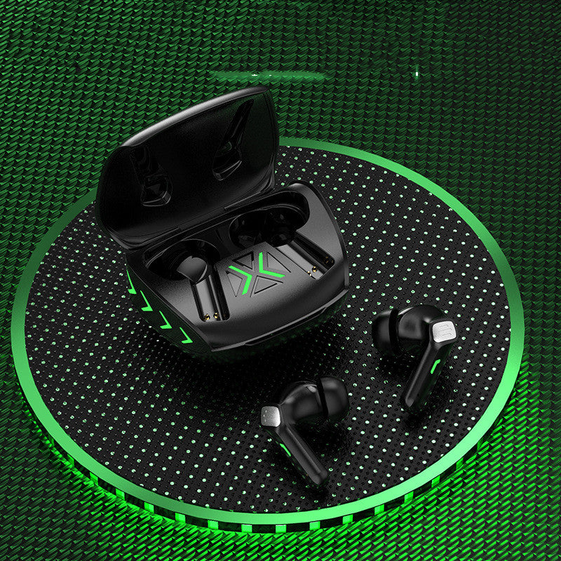 Black wireless earbuds with charging case on a green and black patterned surface