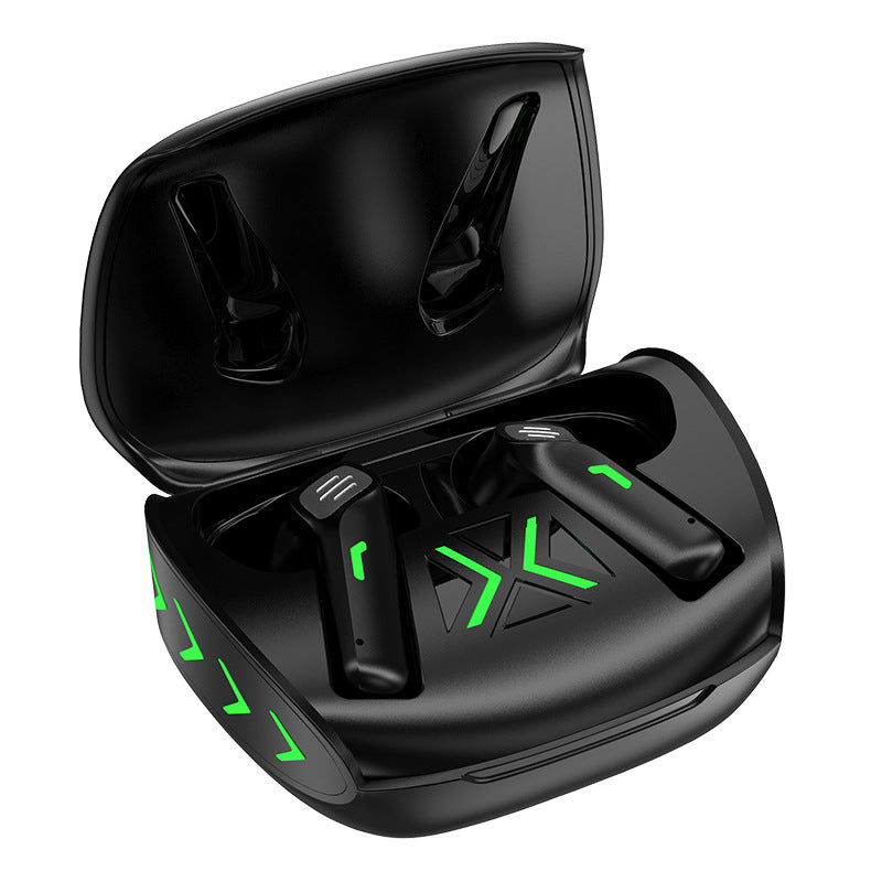Black wireless earbuds with green accents in a charging case on a white background