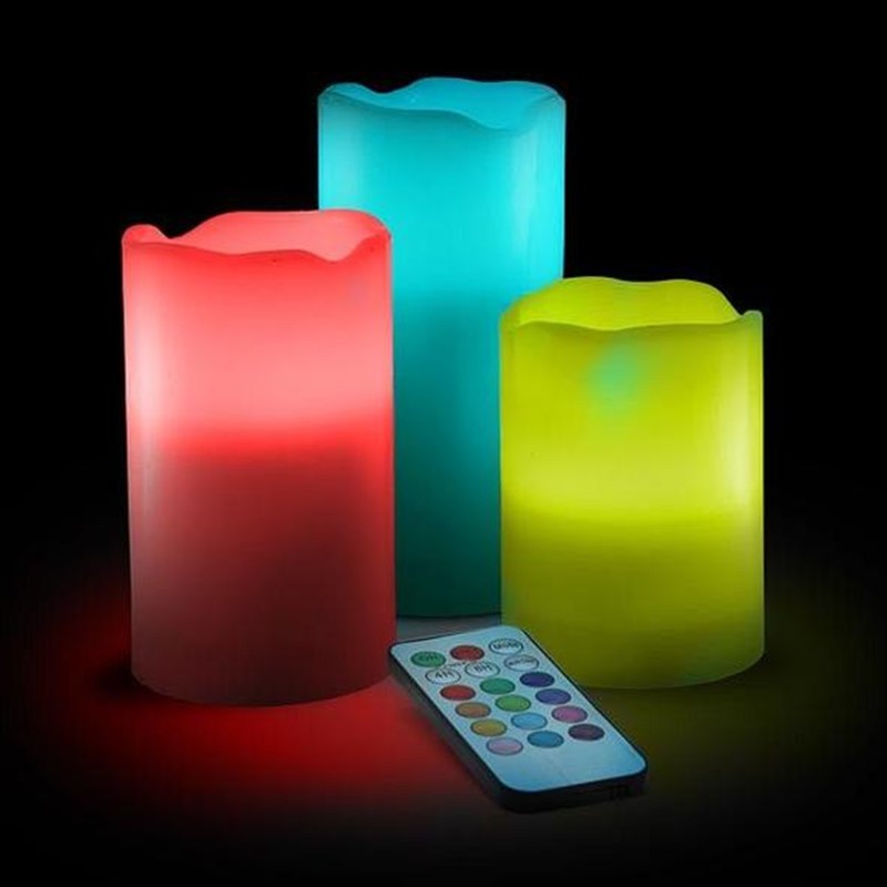 Three colorful LED candles with a remote control on a black background