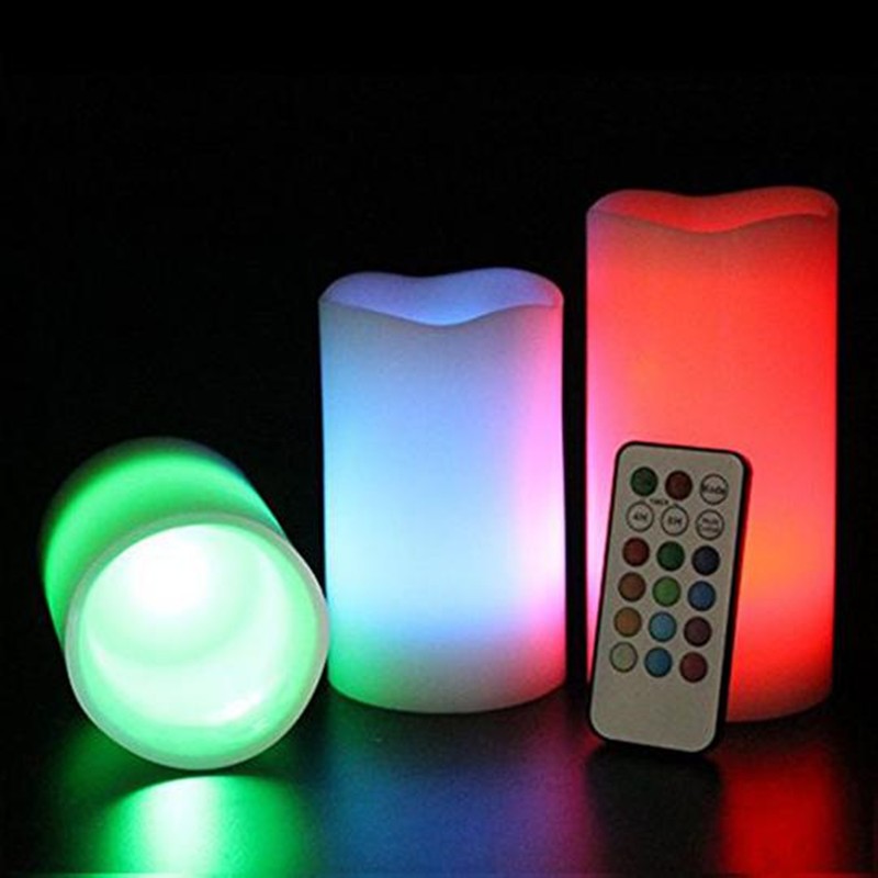 Color-changing LED candles with a remote control on a dark background