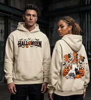 A man and a woman modeling cream-colored hoodies with Halloween graphics. The man wears a front view of the hoodie featuring 'HALLOWEEN' text with pumpkins and bats.