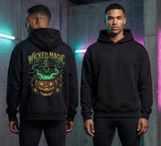 Two male models wearing a black hoodie, showing the front and back views. The back of the hoodie features a large graphic print with the text 'WICKED MAGIC' in green and orange, depicting a witch with a glowing green hat and a jack-o'-lantern pumpkin.