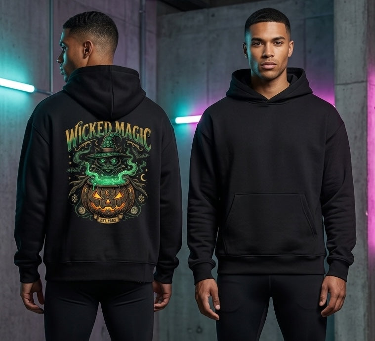 Two male models wearing a black hoodie, showing the front and back views. The back of the hoodie features a large graphic print with the text 'WICKED MAGIC' in green and orange, depicting a witch with a glowing green hat and a jack-o'-lantern pumpkin.