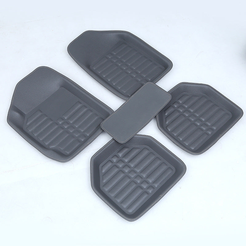 Four gray car floor mats on a white background