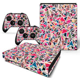 Gaming console and controllers with colorful geometric pattern